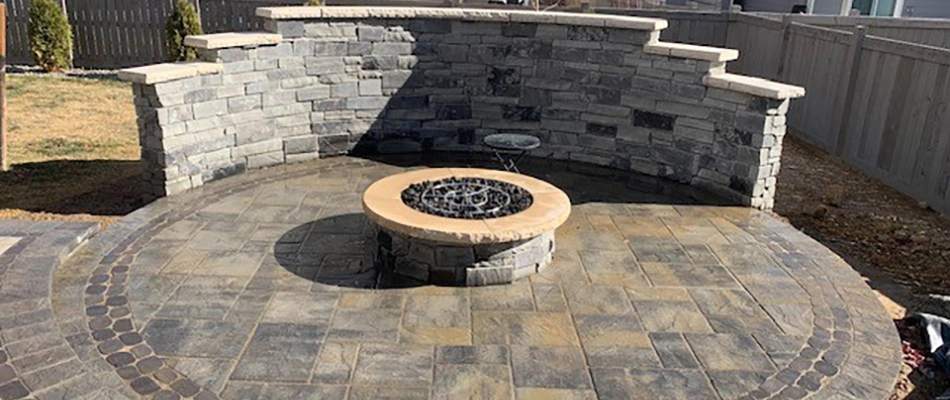 Fire pit installed over patio with retaining wall in Fort Collins, CO.