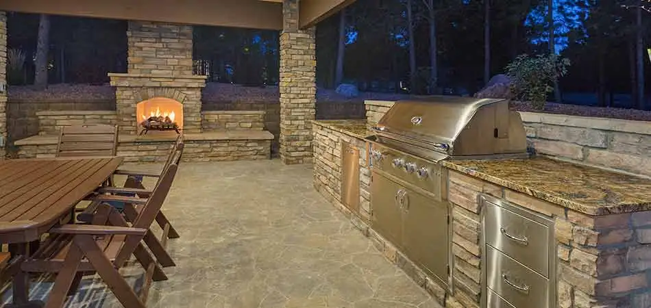 Custom stone outdoor kitchen living area in Golden, CO.