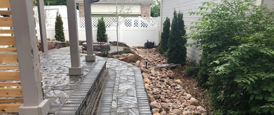 This custom landscaping and dry creek bed accentuates the hardscaping at this project in Denver, CO.