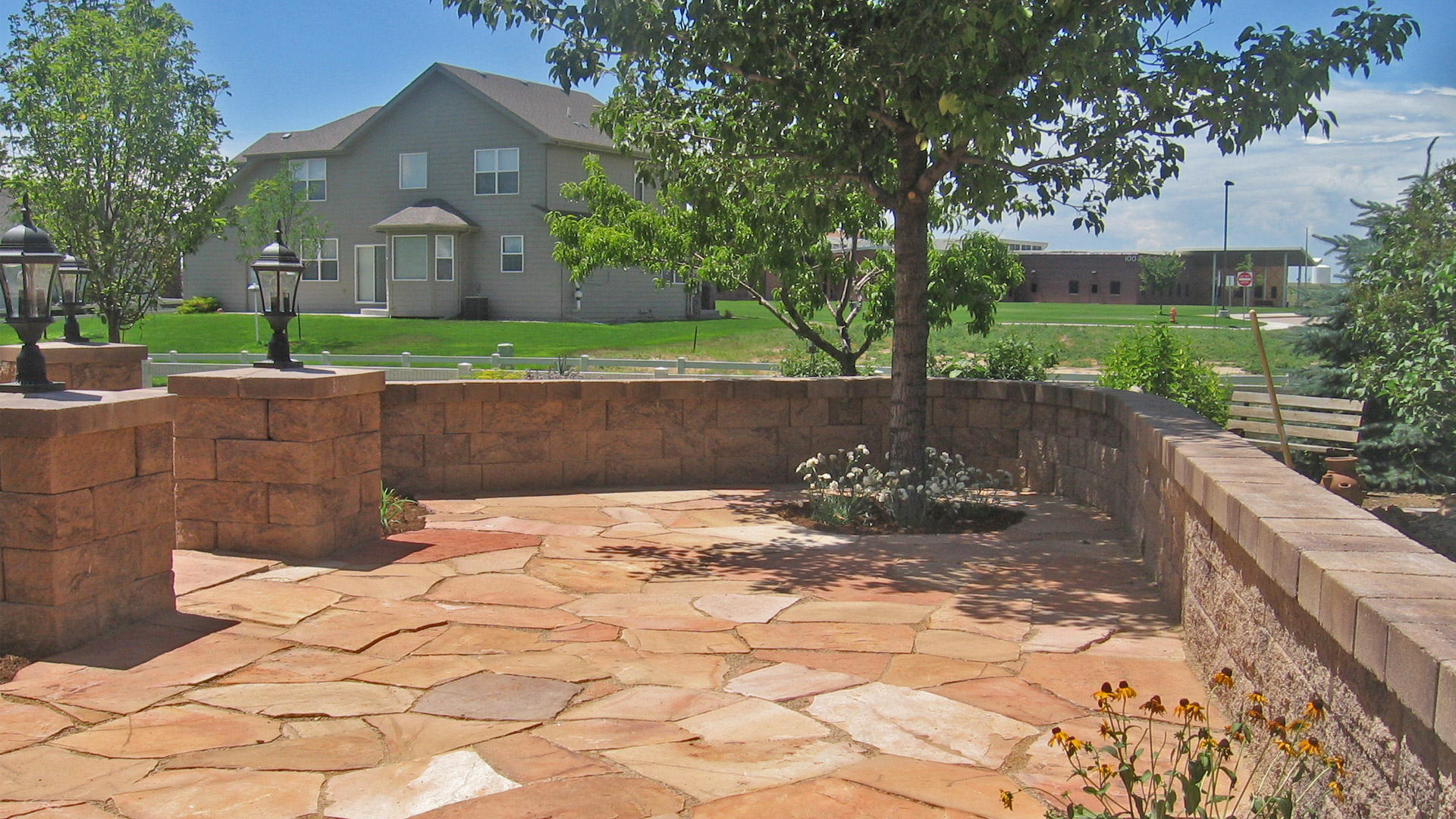 A new seating wall built around the clients recently installed patio in the backyard of a home in Loveland, CO.