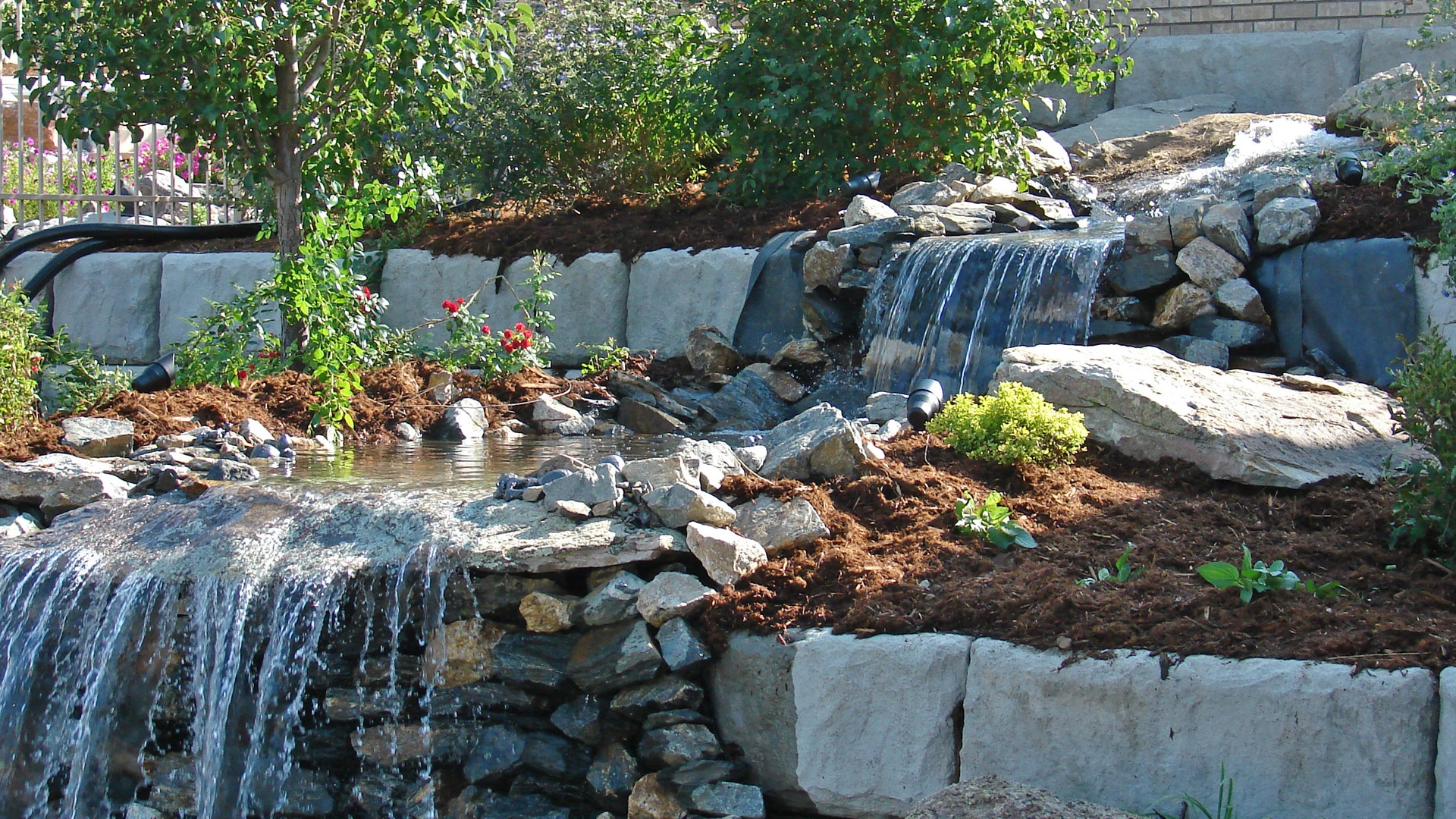 Rock waterfall, pond, stream for the background for our work gallery.