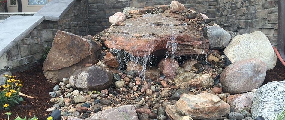 A custom water feature with boulders that was installed by our team for a home in Denver, CO.