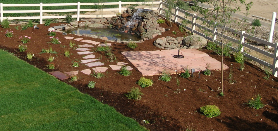 Custom landscaping and water feature at a home in Windsor, CO.