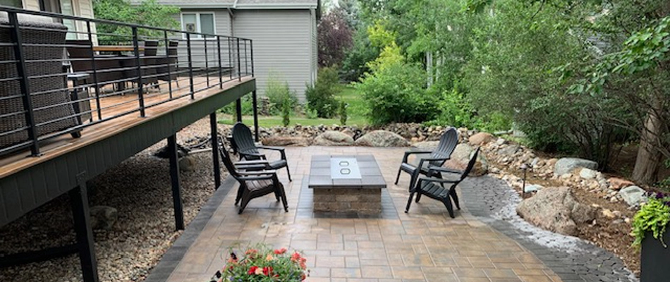 Patio area in Fort Collins, CO, with a fire feature that’s surrounded by chairs.