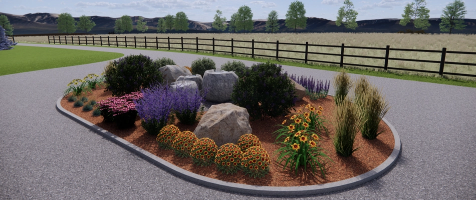A variety of plants in an oval-shaped landscape bed with mulch and boulders.
