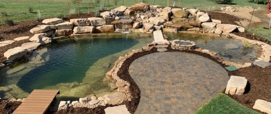 Inground swimming pool surrounded by rocks in Fort Collins, CO.