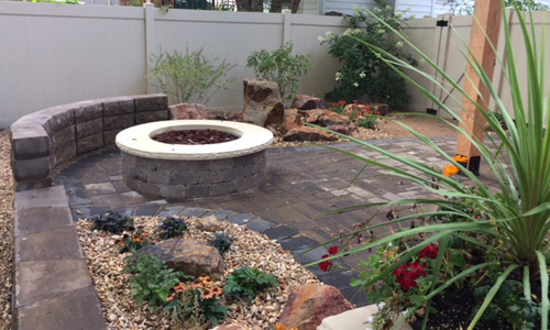 Custom fire pit and seating wall construction in Fort Collins, CO.